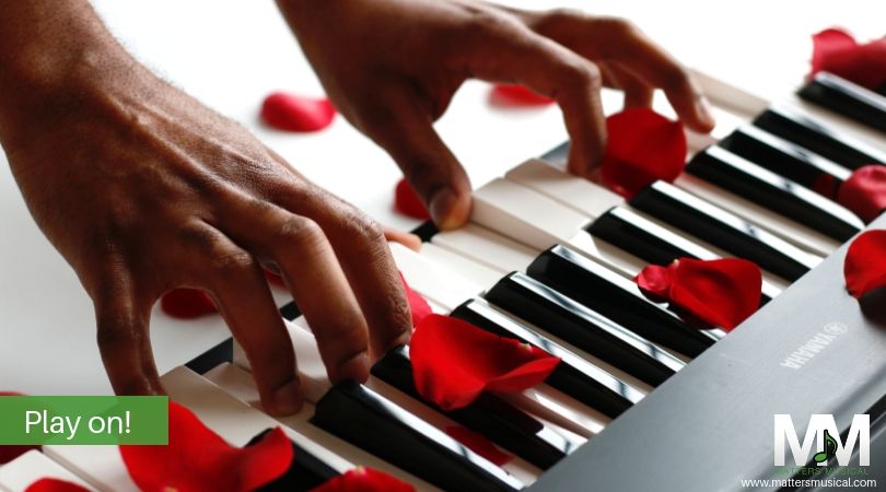 Hands on keyboard with rose petals - valentine music